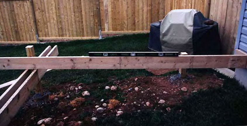 A deck beam running parallel to the house, supporting a joist.