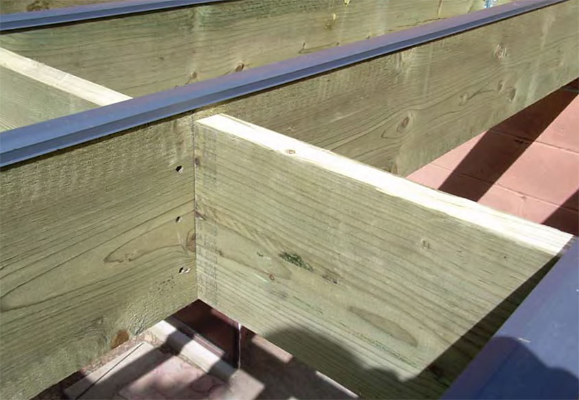Blocked deck joists with Shadoe Track running along the top of the joists.