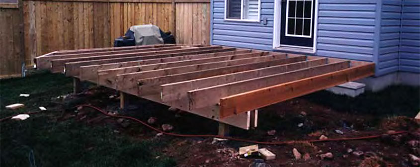 Deck under construction with deck joists sitting on top of the deck beams.