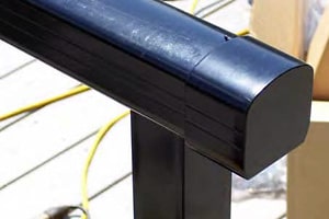 End cap on top rail of aluminum deck railing.