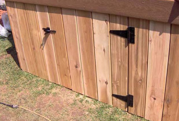 A gate installed in a deck skirt to allow for storage beneath the deck.