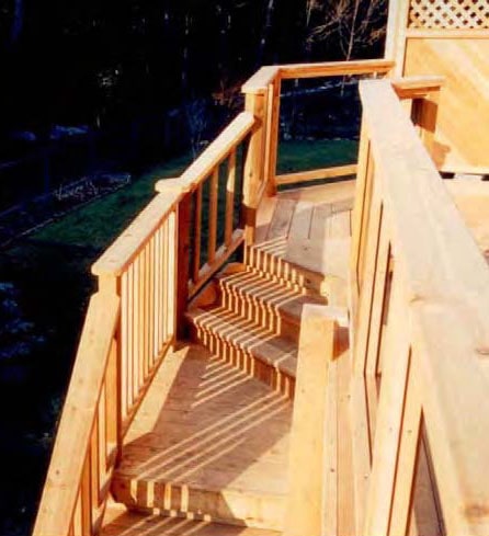 Stairs from a high deck with a landing part way down to change the direction of the stairs.