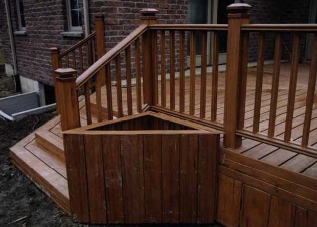 A triangular planter box attached to a deck.