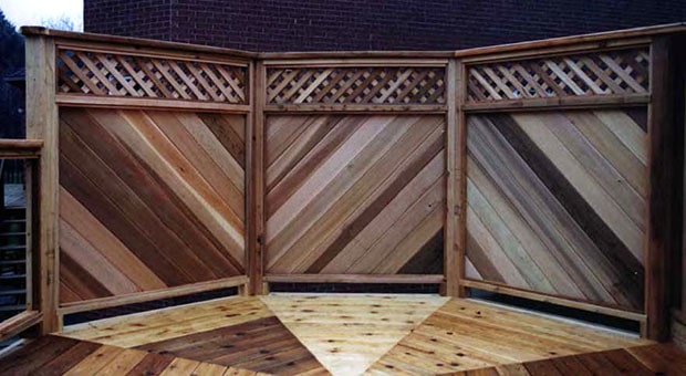 A 3 panel privacy screen with a V-pattern attached to a deck.