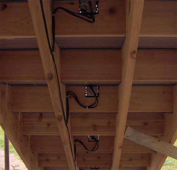 Underside of deck steps showing low voltage deck lighting junction boxes and wiring.