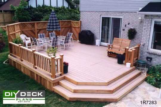 Large single level deck attached to a white brick house