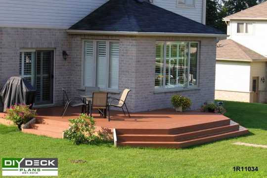 Low single level deck attached to a grey brick house.