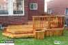 Medium sized cedar deck with an integrated planter box and a bench attached to a red brick house.