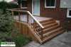 Medium size single level deck attached to a red brick house.